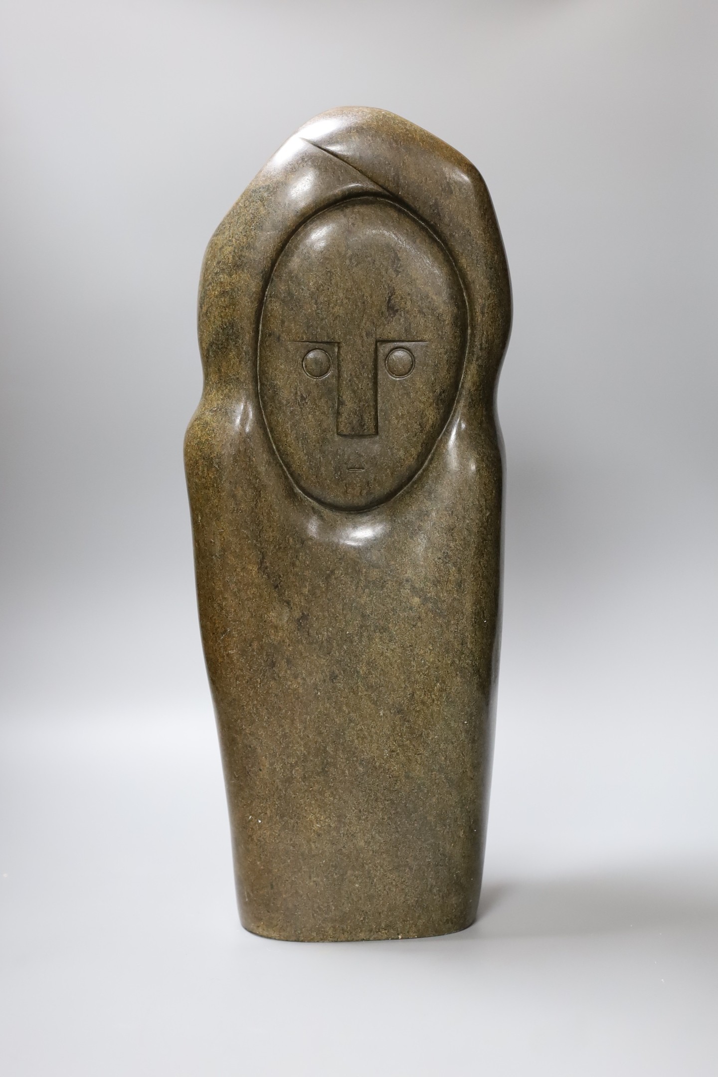 A Zimbabwean carved and polished stone slender abstract figure, 48cm tall